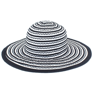 Detailed close-up of woven wide brim sun hat with black and white striped wavy pattern