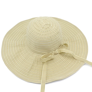 Detail of striped woven sun hat with wide brim and elegant bow tie decoration