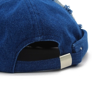 Detail of dark blue denim miki hat with adjustable metal buckle and distressed edge