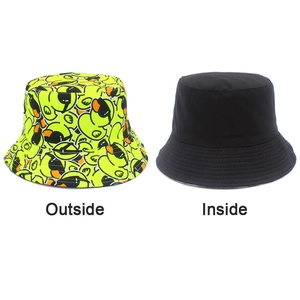 Detail view of double-sided bucket hat showing yellow duck print and plain black lining