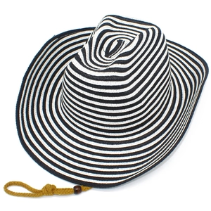 Detail of black and white woven straw fedora hat with a yellow lanyard and wooden bead