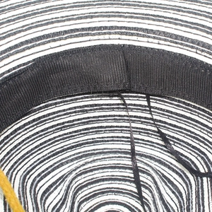Detail of two-tone straw hat interior with black sweatband and adjustable drawstring