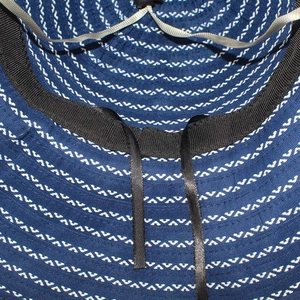 Macro detail of sun hat interior showing blue fiber weave and adjustable drawstring