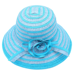 Close-up of wide brim sun hat with blue stripe texture and large floral accent