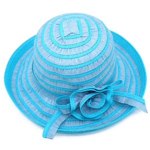Detailed view of striped wide brim sun hat with light blue ribbon flower ornament