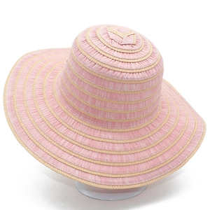 Close-up detail of the pink and beige striped woven texture on wide brim sun hat