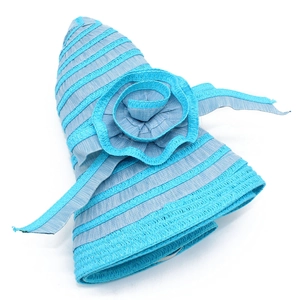 Detail of light blue striped straw sun hat featuring a large woven floral decoration
