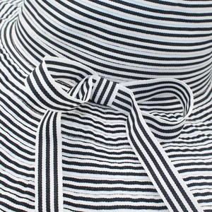 Close-up of the black and white striped sun hat texture with a bow decoration
