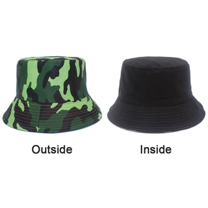 Dual-sided bucket hat featuring green camouflage and solid black foldable fabric