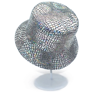 Shiny silver holographic bucket hat with crocodile pattern texture on a white stand
