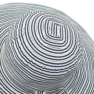 Close-up of black and white striped sun hat showing woven texture and top stitching