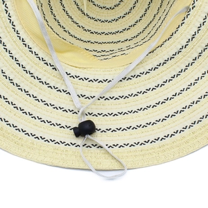 Detail of striped straw sun hat with white windproof cord and adjustable buckle