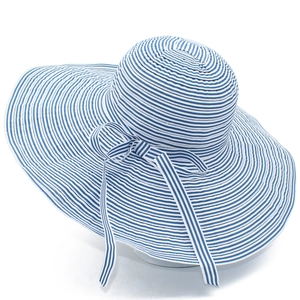 Women's wide brim straw sun hat with blue and white stripes and a decorative bow tie