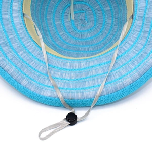 Detail of blue and white straw sun hat showing inner sweatband and adjustable wind rope