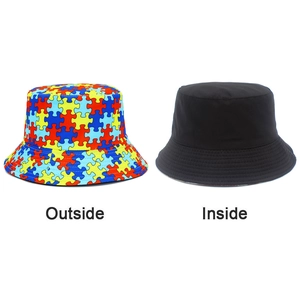 Detail of reversible bucket hat showing colorful puzzle print and solid black lining