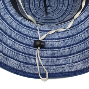 Detail of blue and white striped straw hat showing adjustable grey windproof chin strap