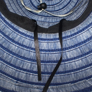 Detail view of woven sun hat interior with sweatband and adjustable windproof strap