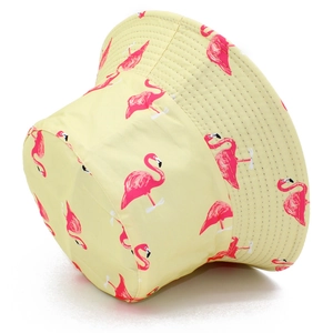 Yellow reversible bucket hat with pink flamingo pattern for sun protection and outdoor use