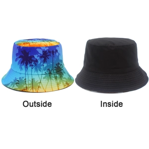 Detail of reversible bucket hat showing vibrant tropical palm tree print and black interior side