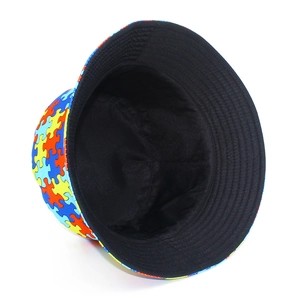 Detailed close-up of vibrant puzzle pattern print on cotton bucket hat with black lining