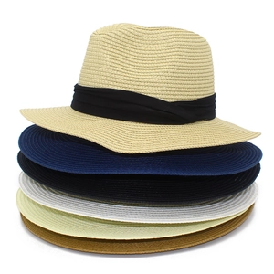 Detailed stack of woven Panama straw hats in six colors with black ribbon trim