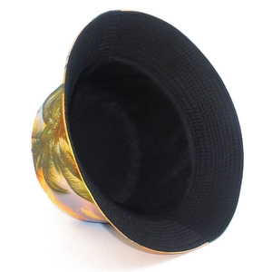 Detail of reversible bucket hat showing palm tree print and solid black fabric side