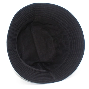Detail view showing the interior stitching and wide brim of the black cotton bucket hat