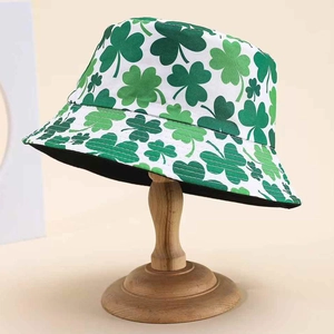 Reversible bucket hat with green shamrock leaf print on white cotton for sun protection