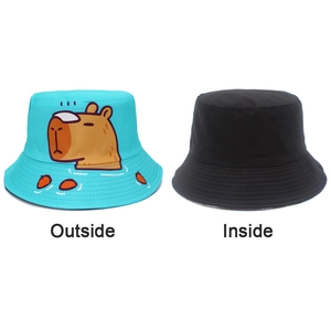 Detail of reversible Capybara bucket hat showing blue cartoon print and black inner side