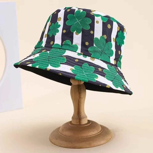 Close-up of bucket hat with green shamrock pattern and striped fabric detail