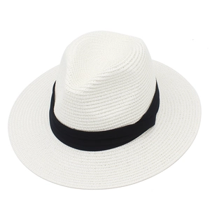 Detail of white woven Panama hat with black decorative ribbon for sun protection