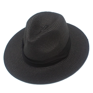 Close-up of black Panama straw hat with ribbon band detail for sun protection
