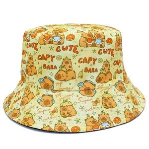 Close-up of yellow bucket hat with cute capybara print and hand-drawn style text