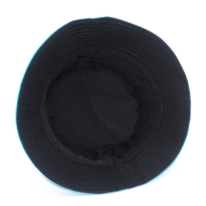 Detail view of the black canvas bucket hat interior with reinforced stitching and blue brim