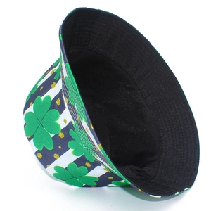 Detail showing green clover leaf patterns and gold glitter dots on striped bucket hat