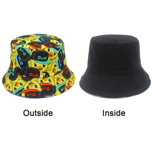 Detail view of the reversible design showing yellow duck print and plain black side