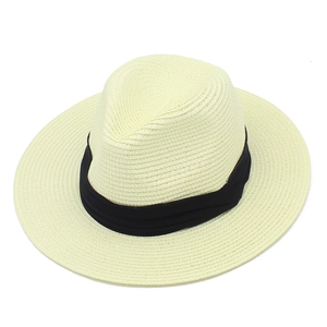 Detail of Panama straw hat featuring fine spiral weave and black pleated decorative ribbon