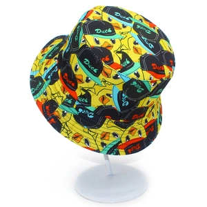 Bright yellow bucket hat with cartoon duck print and Duck lettering on a display stand