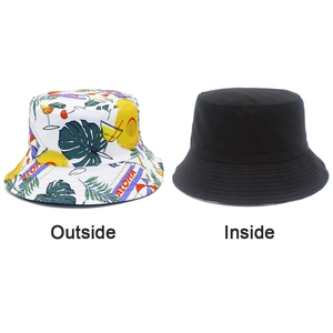 Dual-sided bucket hat detail showing tropical Aloha print and solid black reverse side