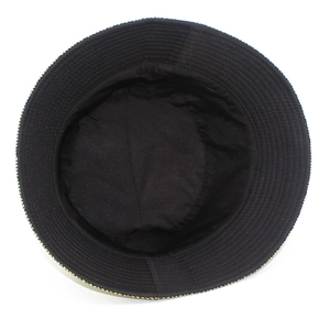 Internal view of black patent leather bucket hat showing lining and stitched brim