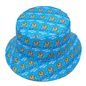 Detailed close-up of blue bucket hat with mermaid capybara patterns and Capy bara text
