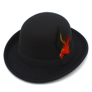 Detailed macro view of a black wool felt jazz hat featuring a colorful decorative feather