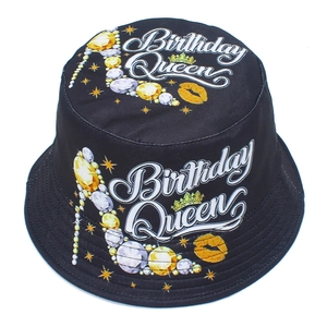 Detail of black Birthday Queen bucket hat featuring golden heel and lip print