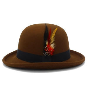 Detailed texture of brown wool bowler hat featuring black ribbon and colored feathers