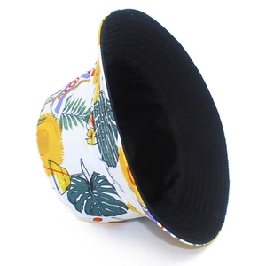 Reversible bucket hat with white tropical plant prints and solid black inner side