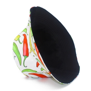 Detailed view of white bucket hat with vibrant red and yellow chili pepper prints
