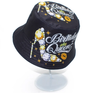 Detail of Birthday Queen print with jewelry stiletto and crown on a black bucket hat