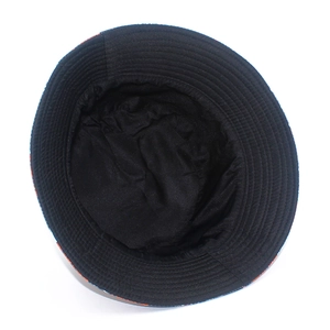 Detail of reinforced stitching on brim of black bucket hat with colorful skull pattern
