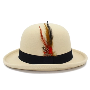 Detail of classic wool bowler hat featuring decorative feathers and black grosgrain ribbon