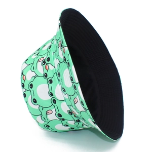 Detail of reversible frog pattern bucket hat showing both printed and solid black sides